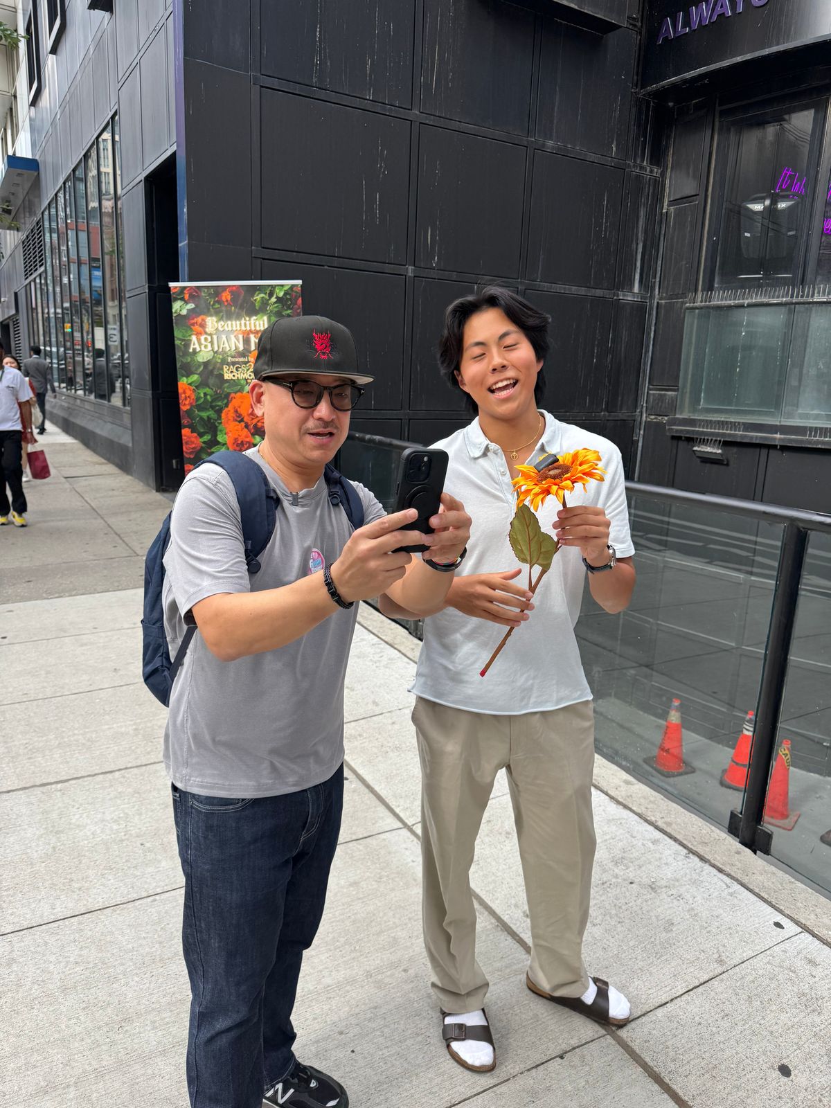 Two participants posing with flowers on King Street